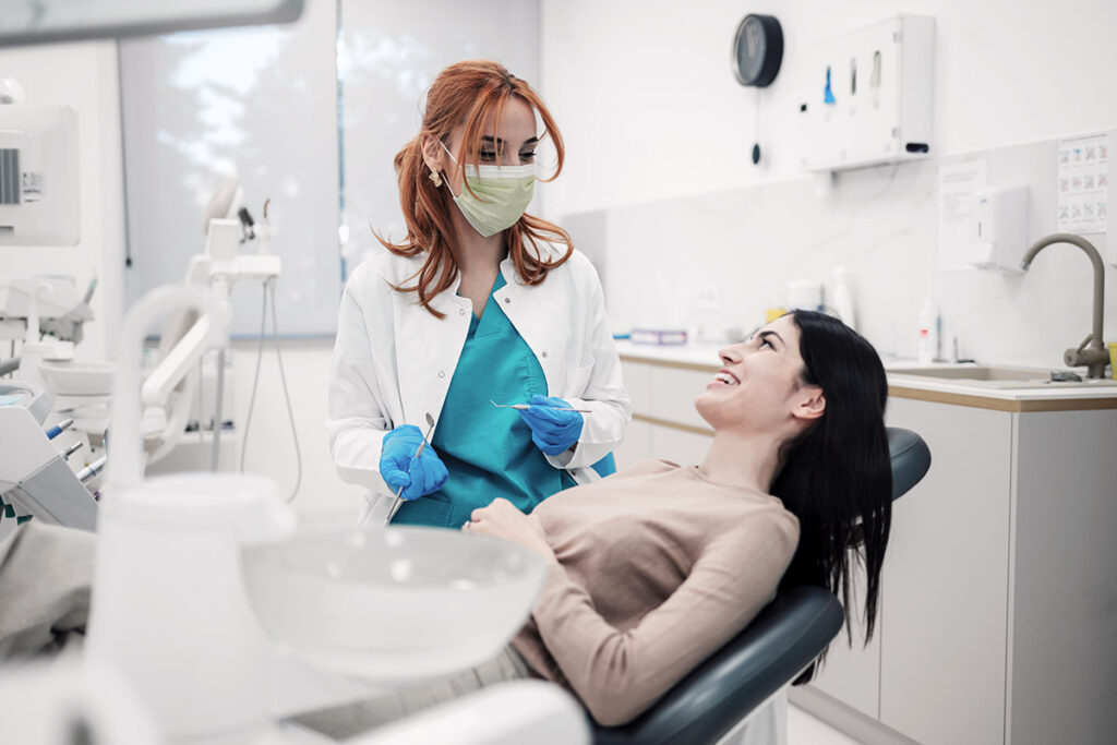 A dentist consulting with her patient during an appointment.