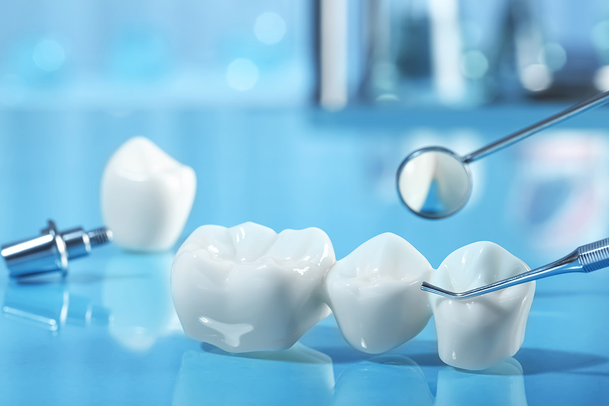 Dental Crowns with dental tools on a blue background.
