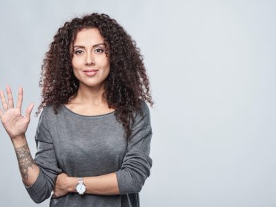 Hand counting - five fingers. Smiling woman showing five fingers