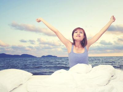 A woman waking up from a restful sleep.