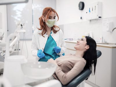 A dentist consulting with her patient during an appointment.