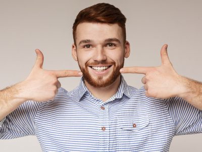 A young man showing off his beautiful smile.